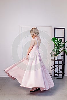 Beautiful young girl in a lush elegant dress in the Studio.