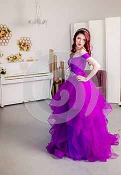 Beautiful young girl in a lush elegant dress in the Studio.