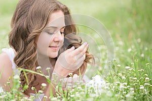 Beautiful young girl lying on the grass