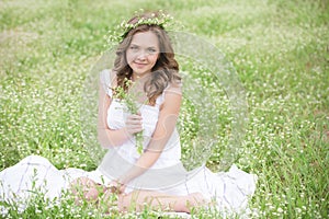 Beautiful young girl lying on the grass