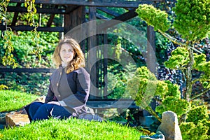 Beautiful young girl meditating in autumn park