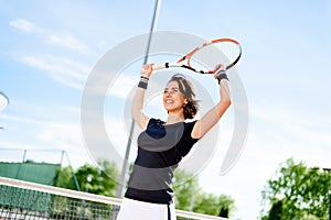 Beautiful young girl on the open tennis court