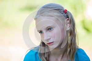 Beautiful young girl outdoors, portrait children close up