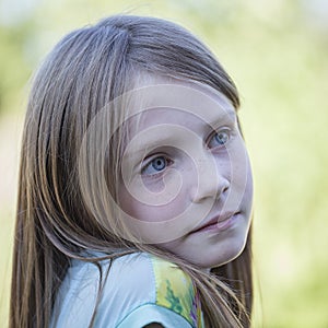 Beautiful young girl outdoors, portrait children close up