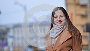 Beautiful young girl portrait in a coat in spring