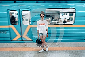 Beautiful young girl posing on metro station
