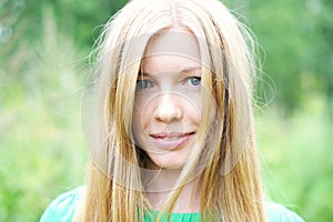 Beautiful young girl posing outdoors in a forest