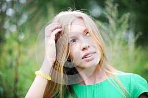 Beautiful young girl posing outdoors in a forest