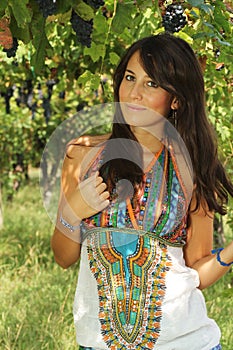 Beautiful young girl posing in a vineyard