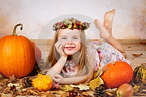 Beautiful young girl with pumpkins