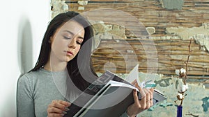 Beautiful young girl reading a glossy magazine