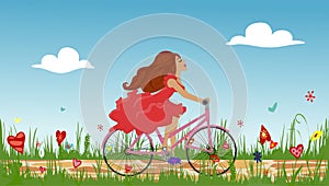 Beautiful young girl riding bike on spring flowering field.