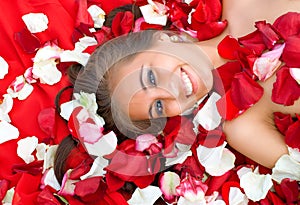 Beautiful young girl in rose petal