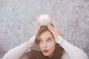 Beautiful young girl saving money for holiday season