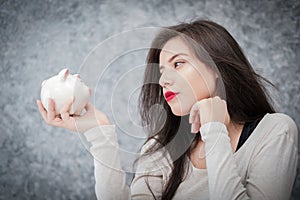 Beautiful young girl saving money for holiday season