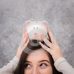 Beautiful young girl saving money for holiday season, saving