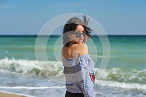 Beautiful young girl on the sea coast