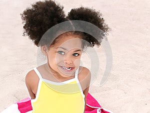 Beautiful Young Girl Sitting On Beach Towel In The Sand