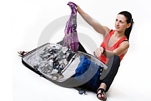 Young woman preparing her baggage before travel photo