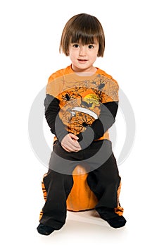 Beautiful young girl sitting on Pumpkin