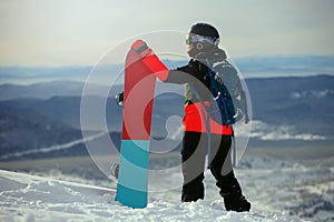 Beautiful young girl with a snowboard