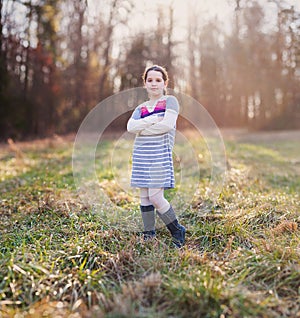 Beautiful young girl standing in a field