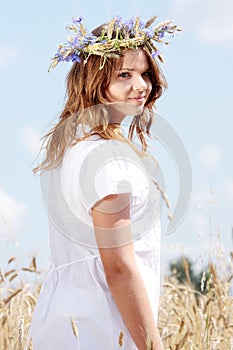 Beautiful young girl in summer field