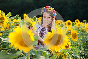 Beautiful young girl at sunflower field