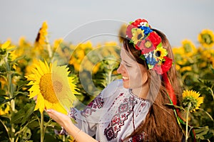 Beautiful young girl at sunflower field