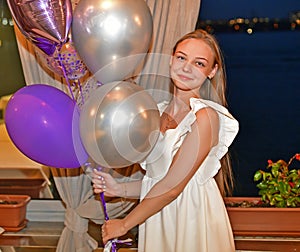 Beautiful young girl teenager with balloons.