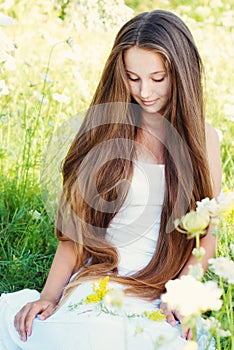 Beautiful Young Girl with very Long Hair Outdoors.