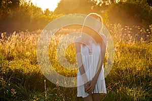 Beautiful young girl walking in the evening outdoors