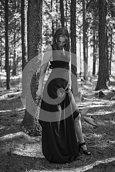 Beautiful young girl walking in a fairy forest.