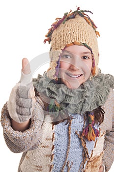 Beautiful young girl in warm winter clothes showing thumb up