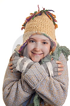 Beautiful young girl in warm winter clothes smiles