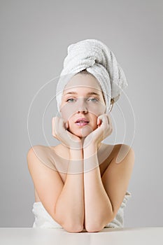 Beautiful young girl wearing white towel on her head