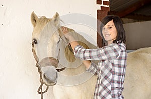 Beautiful young girl and white horse