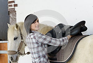 Beautiful young girl and white horse