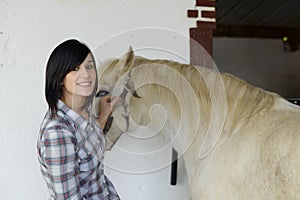 Beautiful young girl and white horse