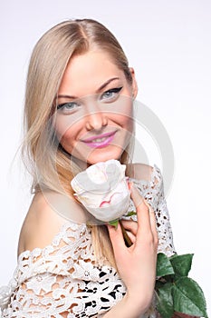 Beautiful young girl with a white rose