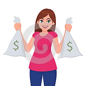 Beautiful young girl, woman or female holding/showing money, cash or currency notes bags with dollar sign. Successful business.