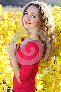 Beautiful young girl in yellow grape vineyard