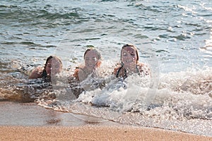 Waves Splash Girls Laying on the Sand
