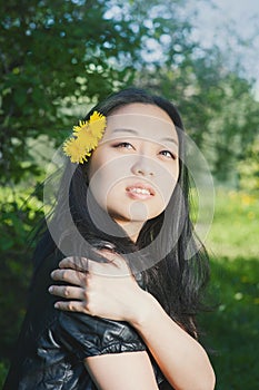 Beautiful young happy smiling asian woman with dandelion flowers