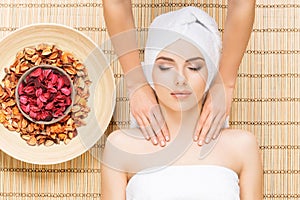 Beautiful, young and healthy woman on bamboo mat in spa salon ha