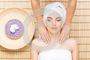 Beautiful, young and healthy woman on bamboo mat in spa salon ha