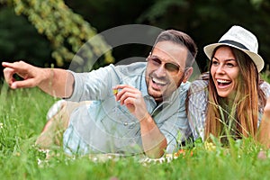 Beautiful young heterosexual couple having a great time during picnic in a park