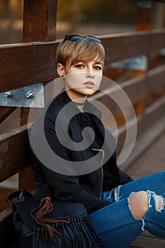 Beautiful young hipster woman in a black fashionable jacket