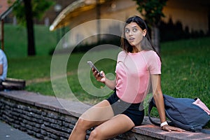 Beautiful young hipster woman using smart phone