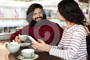 Beautiful young indian couple have romantic date at cafe
